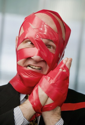 Office Bloke Covered In Red Tape